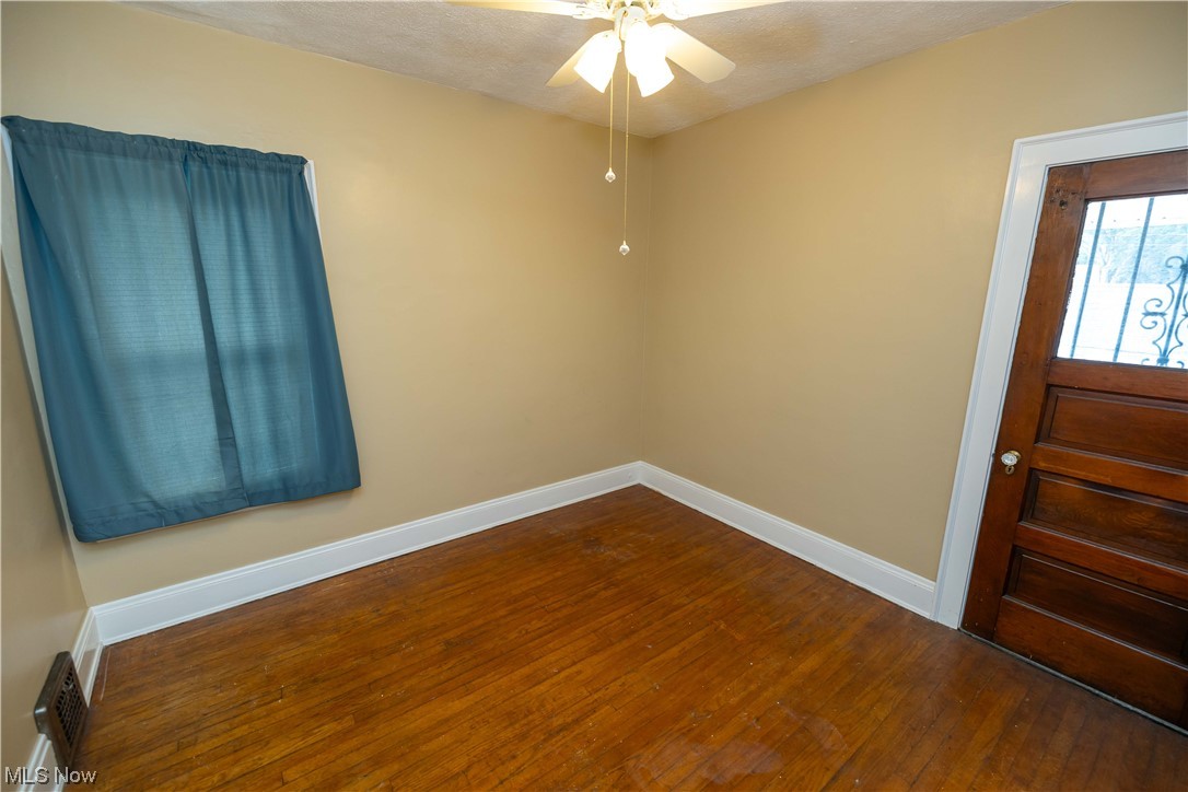 10105 Unity Avenue Cleveland, OH 44111 - Photo 12 of 35 Unfurnished room with dark hardwood flooring and ceiling fan