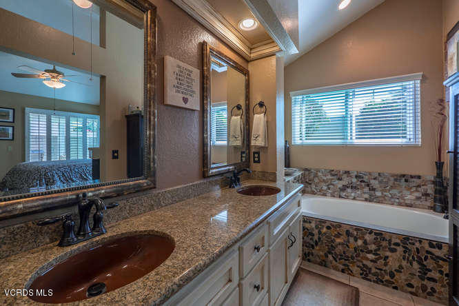 40 Valley Crest Road Simi Valley, CA 93065 - Photo 5 of 38 a bathroom with a granite countertop double vanity sink a mirror and a shower
