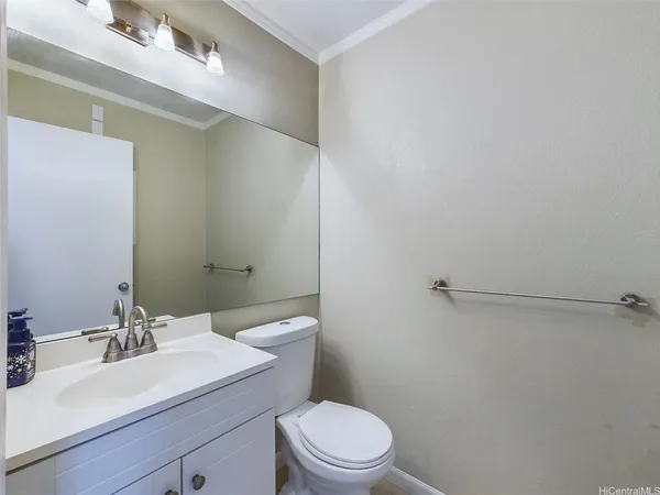 a bathroom with a sink a toilet and vanity