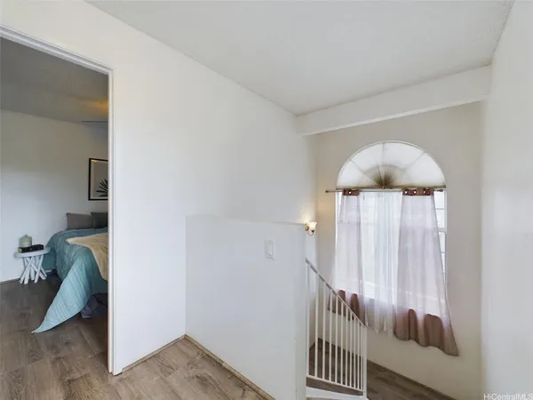 a view of a hallway with entryway and stairs