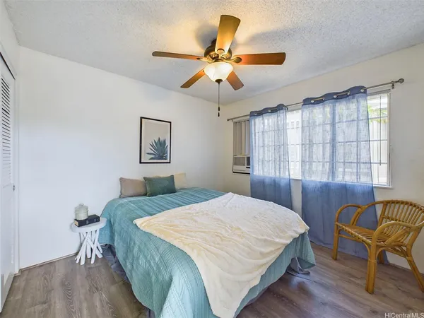 a bedroom with a bed and chair