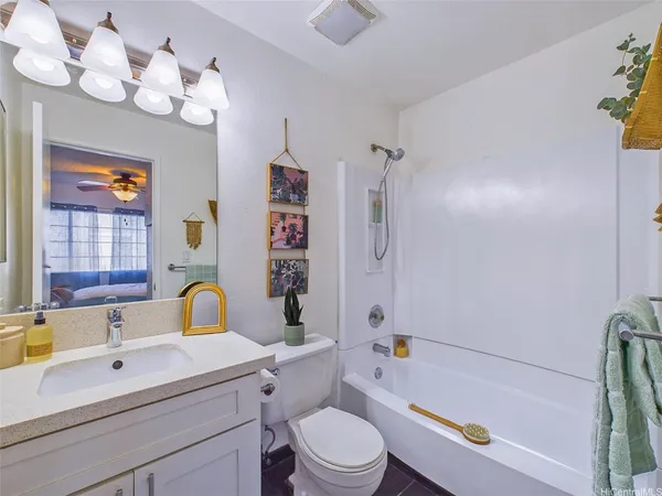 a bathroom with a sink a toilet tub and shower