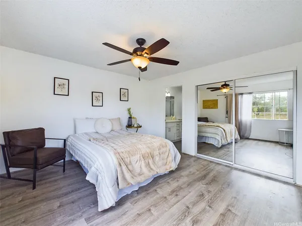 a bedroom with a bed and a chair