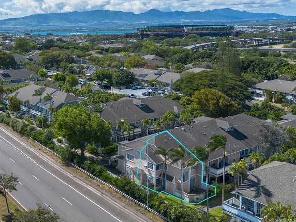 an aerial view of houses with a yard