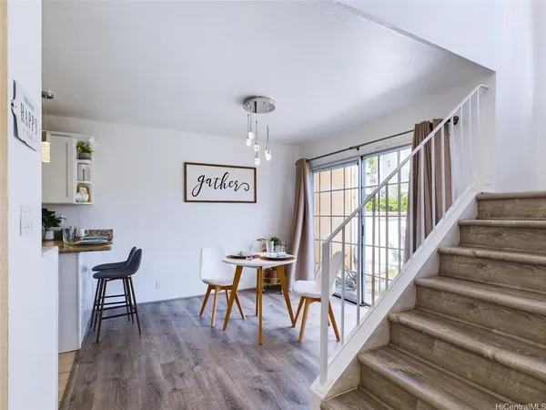 a view of a livingroom with furniture staircase and front door