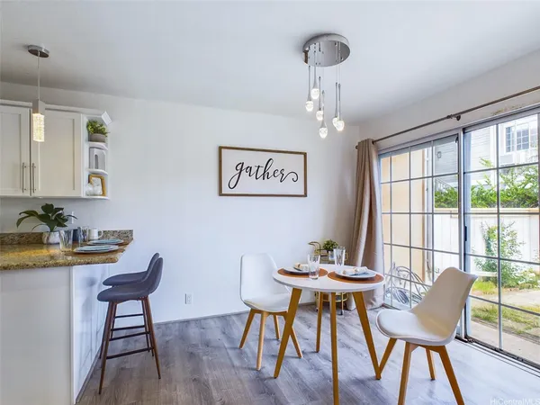 a view of a dining room with furniture window and wooden floor