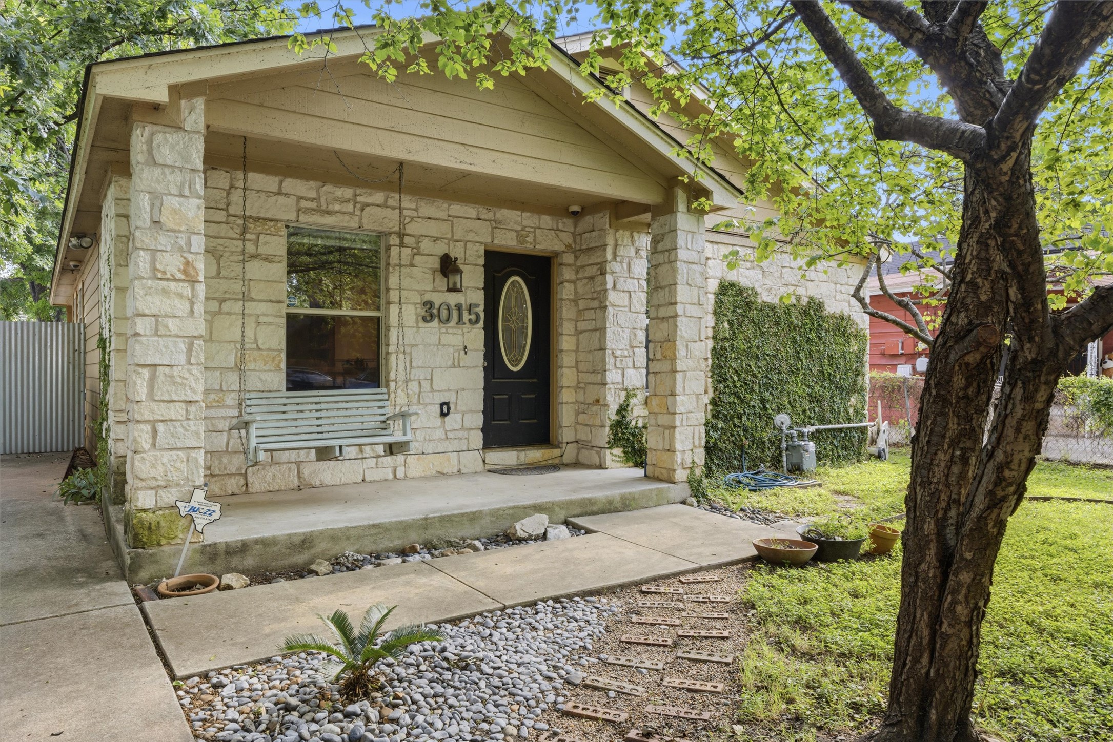3015 Castro Street Austin, TX 78702 - Photo 4 of 40 A charming stone facade with a welcoming front porch and mature landscaping.