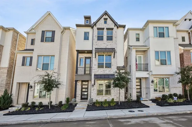 a front view of a residential houses with yard