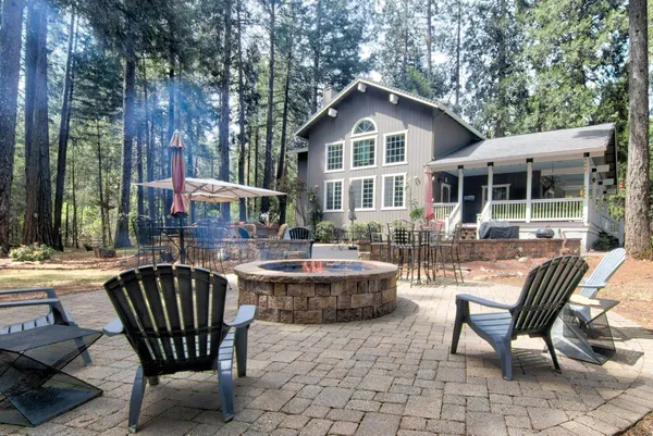 a view of a house with swimming pool and sitting area