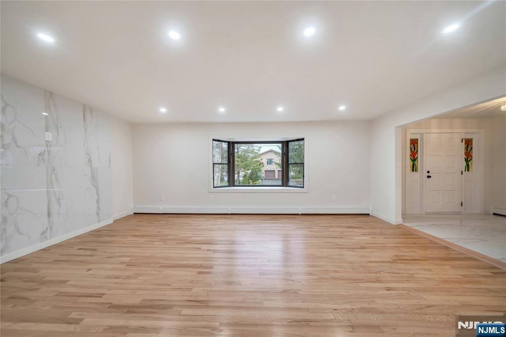 468 Morse Avenue Ridgefield, NJ 07657 - Photo 4 of 48 a view of an empty room with wooden floor and window