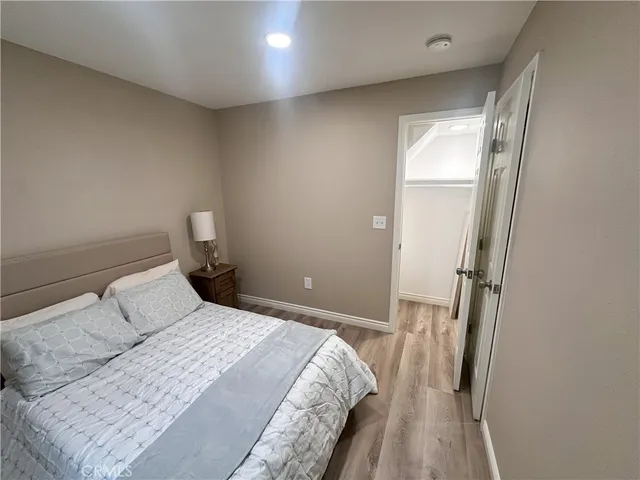 a bedroom with a bed and a mirror