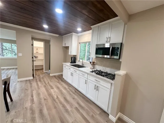 a kitchen with stove and cabinets