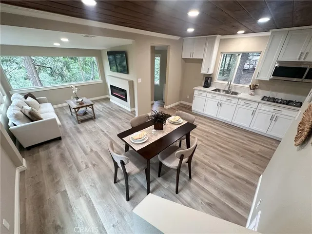 a living room with furniture fireplace and a table