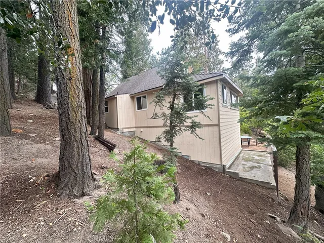 a view of a house with a tree in the yard