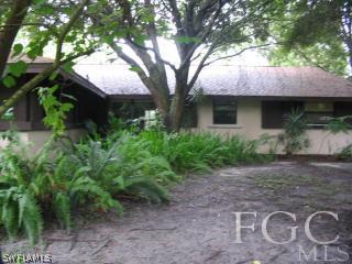 13901 Rod And Gun Club Road Fort Myers, FL 33913 - Photo 1 of 25 a front view of a house with garden