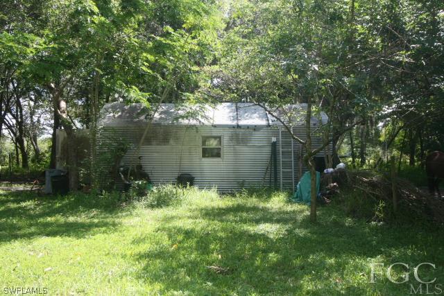 13901 Rod And Gun Club Road Fort Myers, FL 33913 - Photo 12 of 25 a backyard of a house with lots of green space