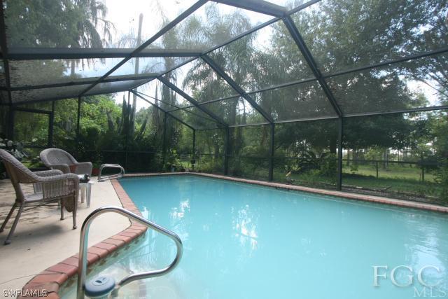 13901 Rod And Gun Club Road Fort Myers, FL 33913 - Photo 15 of 25 a backyard of a house with fountain table and chairs