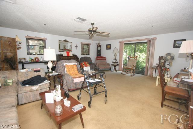 13901 Rod And Gun Club Road Fort Myers, FL 33913 - Photo 23 of 25 a living room with furniture and a chandelier