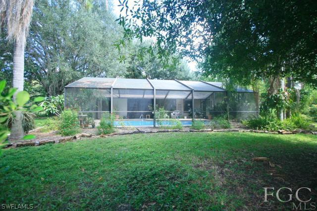 13901 Rod And Gun Club Road Fort Myers, FL 33913 - Photo 4 of 25 a view of a house with a backyard patio and swimming pool