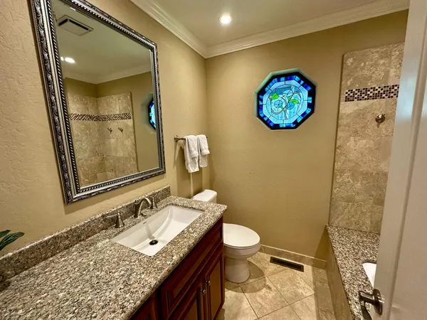a kitchen with granite countertop a sink and a stove next to a window