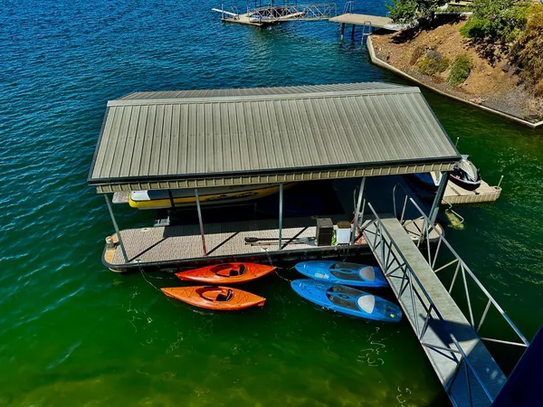 a backyard of a house with barbeque oven table and chairs