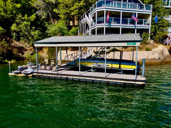 a view of a house with pool and chairs
