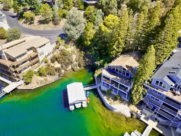 a wooden bench sitting in the middle of a lake