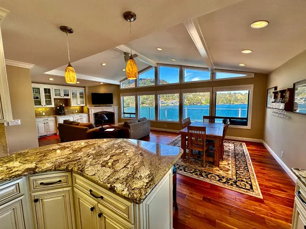 a kitchen with granite countertop a stove and cabinets