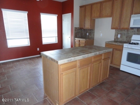 3544 East Mecate Road Tucson, AZ 85739 - Photo 6 of 14 a kitchen with stainless steel appliances granite countertop a sink stove and refrigerator