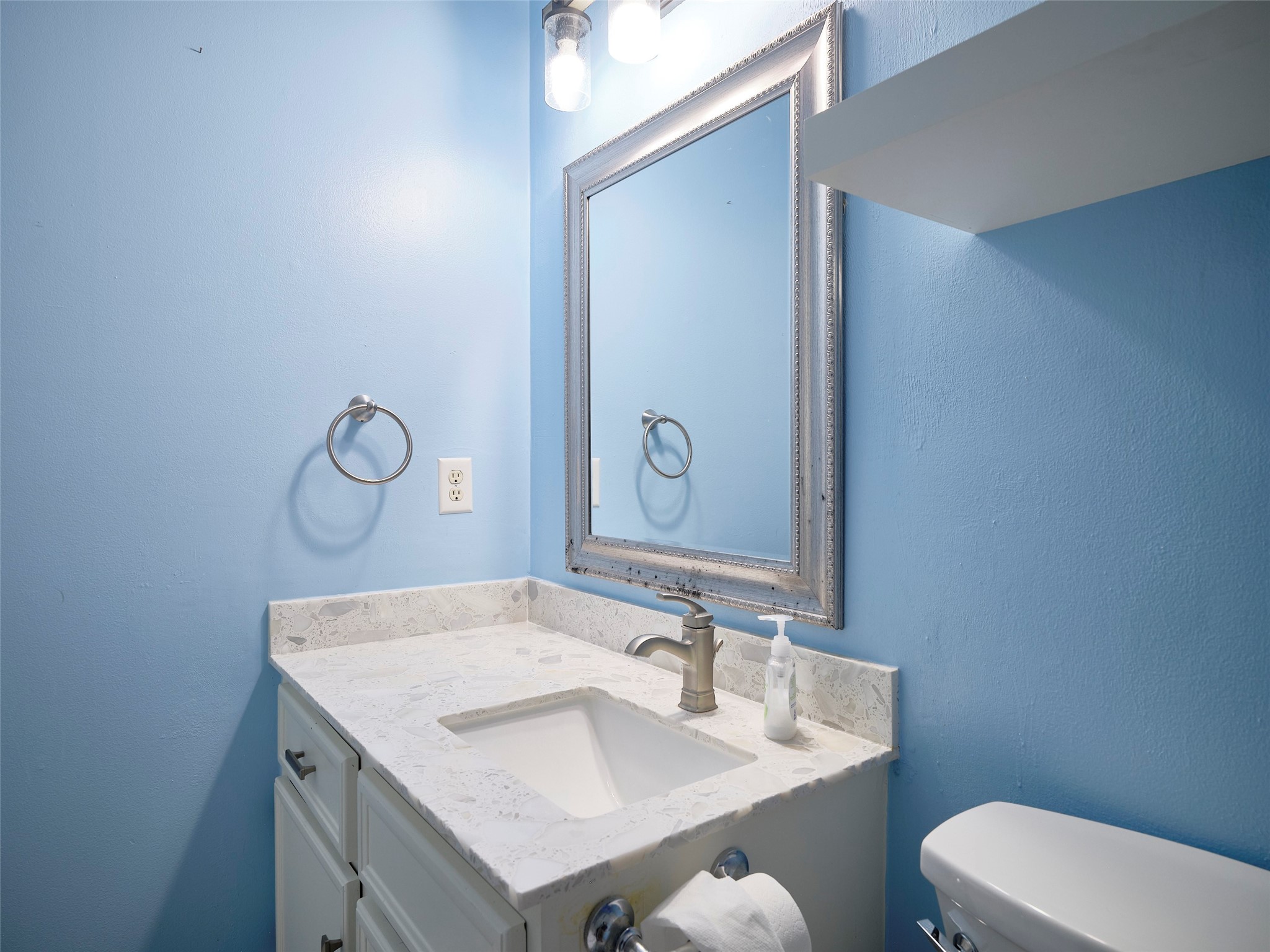1520 Crestmont Street Wharton, TX 77488 - Photo 25 of 38 a bathroom with a granite countertop sink a toilet and mirror