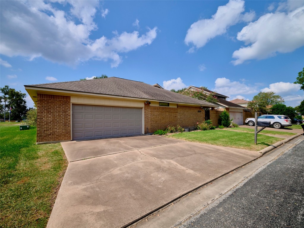 1520 Crestmont Street Wharton, TX 77488 - Photo 5 of 38 a front view of a house with a garden and yard