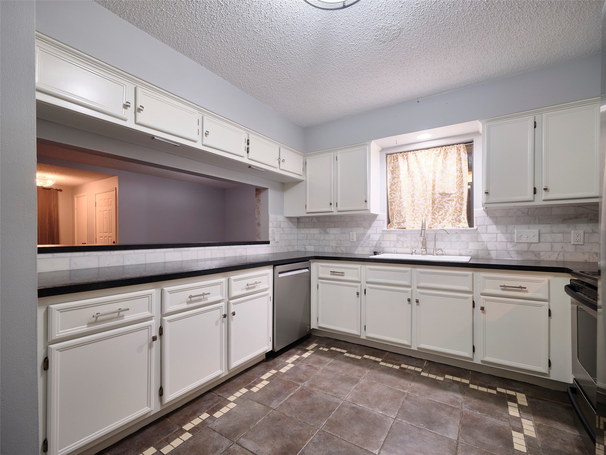 1520 Crestmont Street Wharton, TX 77488 - Photo 10 of 38 a kitchen with granite countertop white cabinets and white appliances