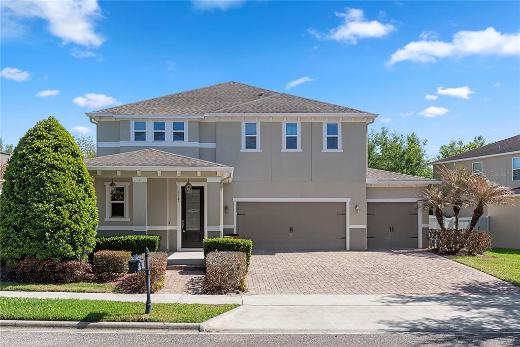 6613 Merrick Landing Boulevard Windermere, FL 34786 - Photo 1 of 1 a front view of a house with garden
