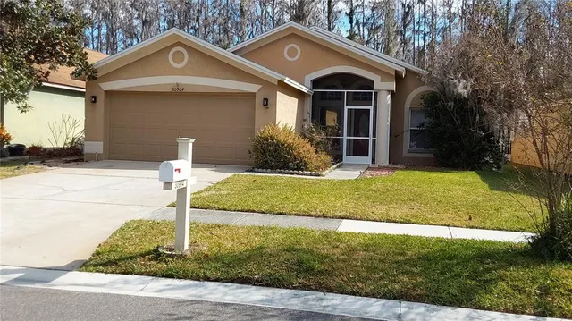 a front view of a house with a yard and garage