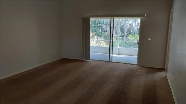 a kitchen with stainless steel appliances a refrigerator stove and white cabinets