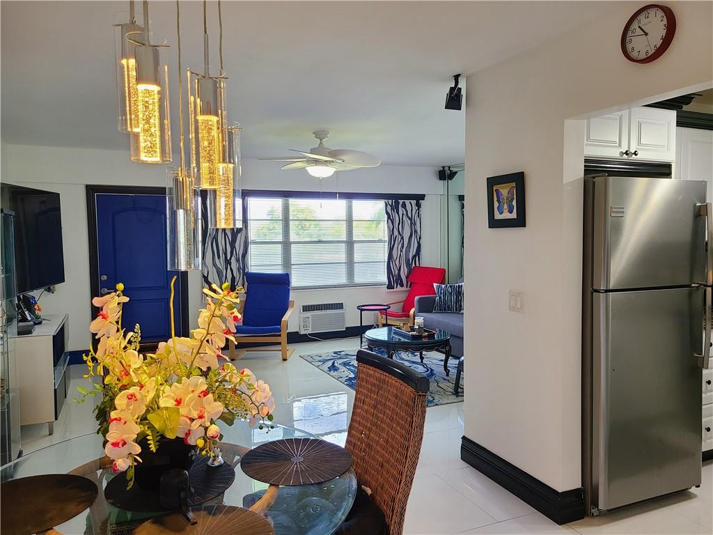 163 Suffolk F, Unit 163 Boca Raton, FL 33434 - Photo 14 of 34 a living room with furniture fireplace and flat screen tv