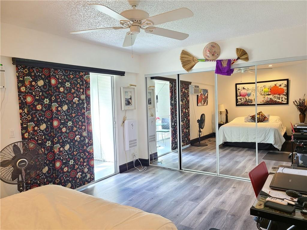 163 Suffolk F, Unit 163 Boca Raton, FL 33434 - Photo 24 of 34 a living room with furniture and a flat screen tv