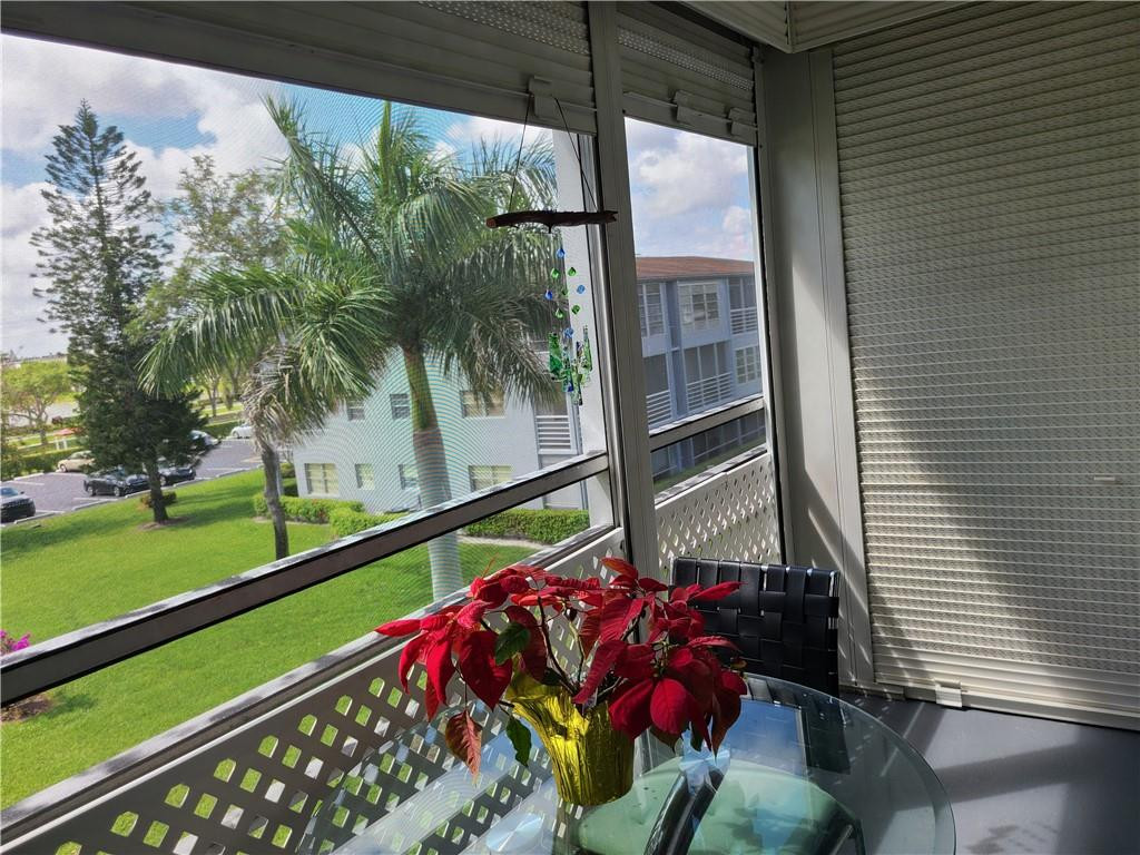 163 Suffolk F, Unit 163 Boca Raton, FL 33434 - Photo 28 of 34 a balcony view with a garden