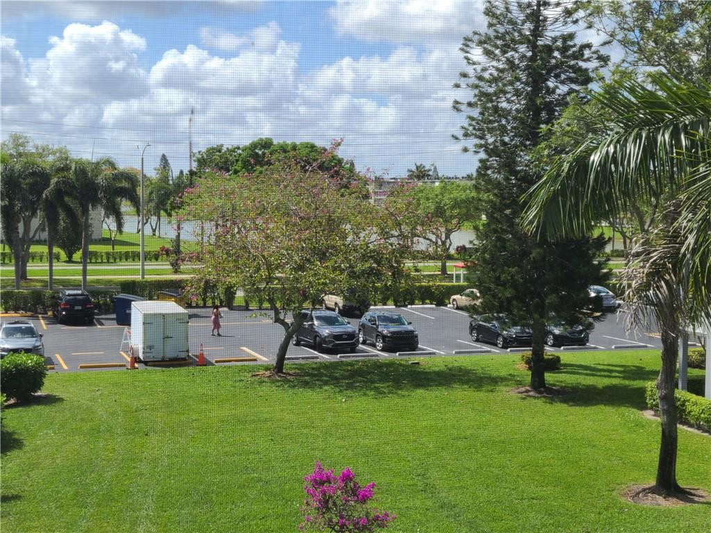 163 Suffolk F, Unit 163 Boca Raton, FL 33434 - Photo 31 of 34 a view of a garden with an outdoor space