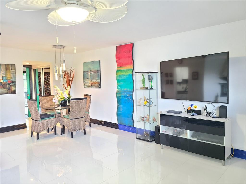 163 Suffolk F, Unit 163 Boca Raton, FL 33434 - Photo 7 of 34 a living room with furniture and a flat screen tv