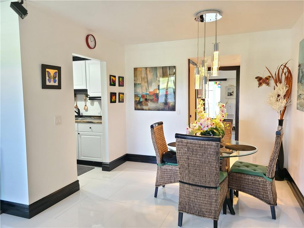 163 Suffolk F, Unit 163 Boca Raton, FL 33434 - Photo 9 of 34 a dining room with furniture and window