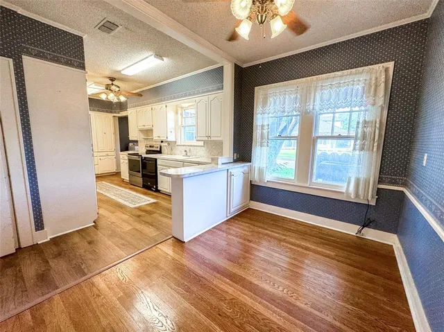 a kitchen with stainless steel appliances granite countertop a stove and a refrigerator
