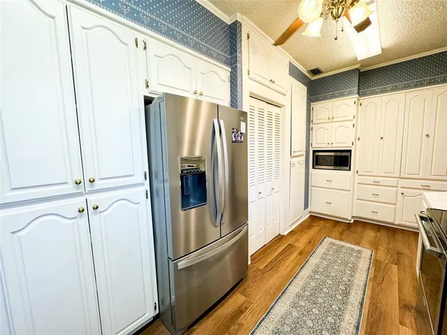 a kitchen with stainless steel appliances a refrigerator and cabinets