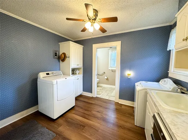 a view of washer and dryer with bathroom in the background