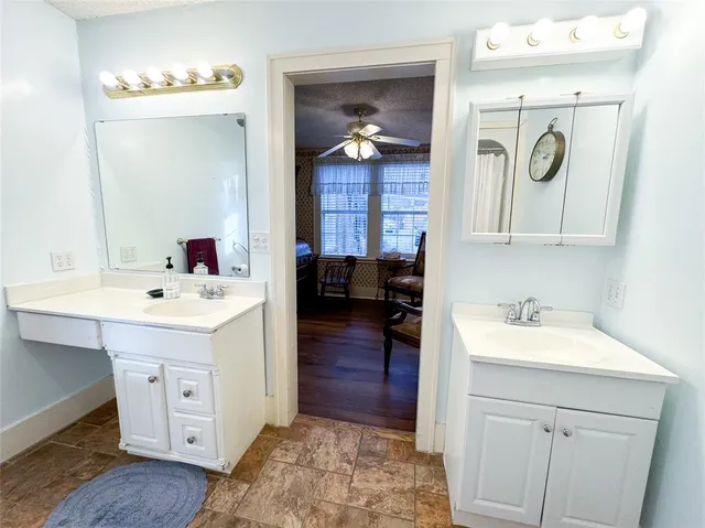 a en suite bathroom with a sink double vanity and a mirror