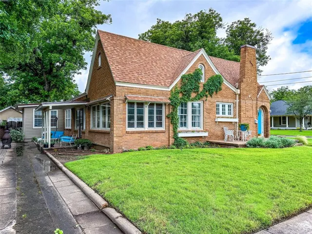 a view of a house with a yard and sitting area