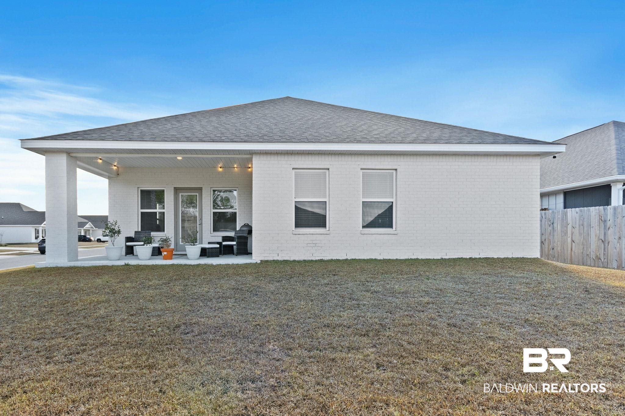 12919 Torrent Road Fairhope, AL 36532 - Photo 47 of 74 Back of house featuring a patio area, brick siding, and roof with shingles