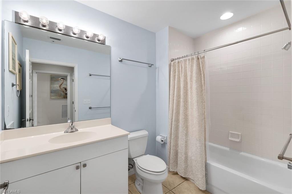 460 Launch Circle, Unit 202 Naples, FL 34108 - Photo 16 of 34 a bathroom with a sink a toilet and shower