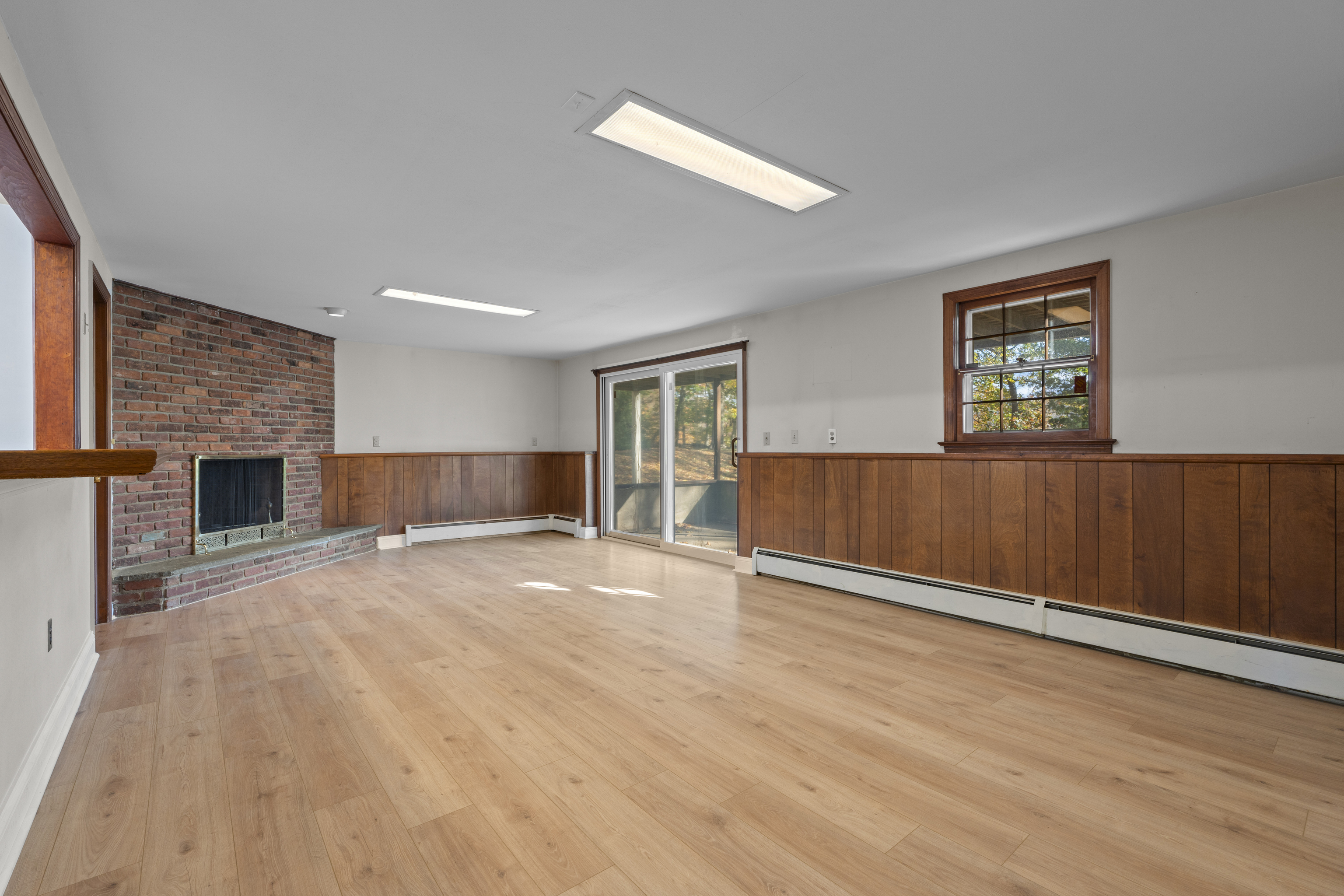 3 Parsell Lane Westport, CT 06880 - Photo 21 of 29 an empty room with wooden floor fireplace and windows