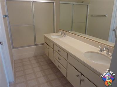 1539 Kings Road Palmdale, CA 93551 - Photo 11 of 22 a spacious bathroom with a double vanity sink and a mirror